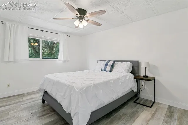 a large bed sitting in a bedroom next to a window