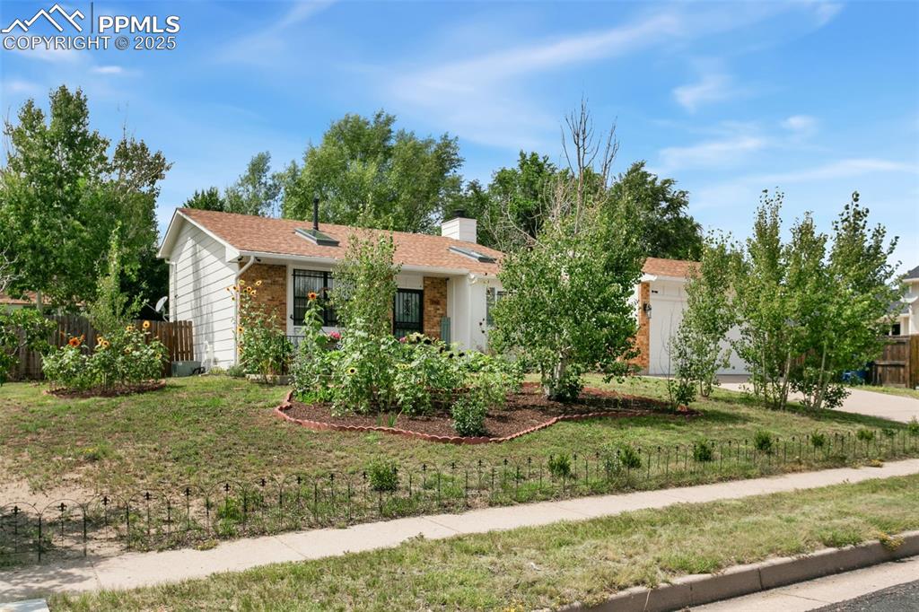 2960 Rio Vista Drive Colorado Springs, CO 80917 - Photo 2 of 32 a front view of a house with a yard