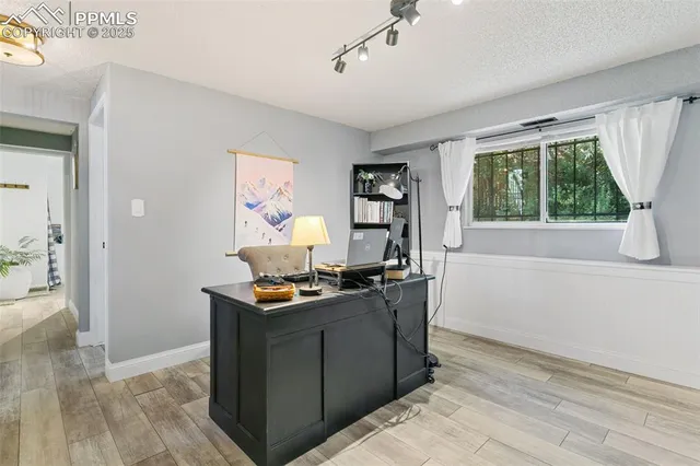 a dining room with wooden floor and a window