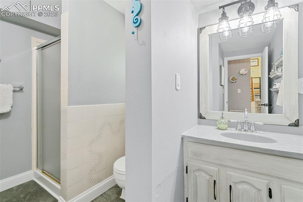 2960 Rio Vista Drive Colorado Springs, CO 80917 - Photo 24 of 32 a bathroom with a sink vanity mirror and toilet