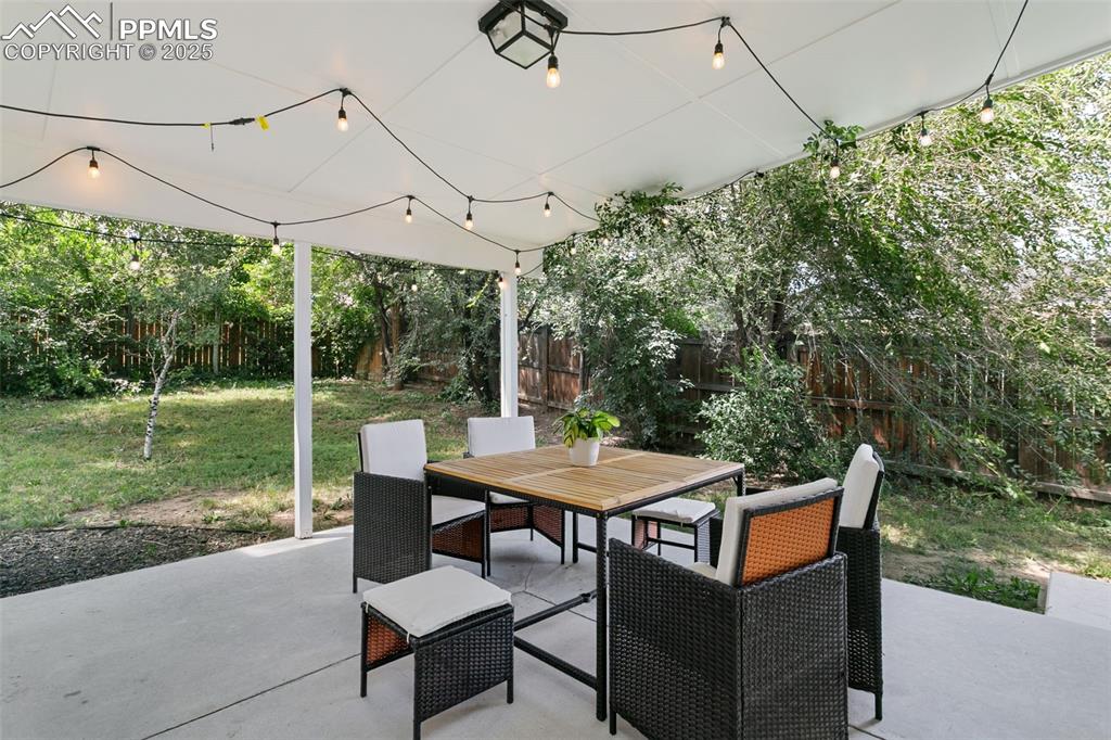 2960 Rio Vista Drive Colorado Springs, CO 80917 - Photo 26 of 32 a view of a patio with a table chairs and a backyard