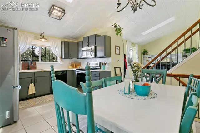 a view of a dining room with furniture and a potted plant