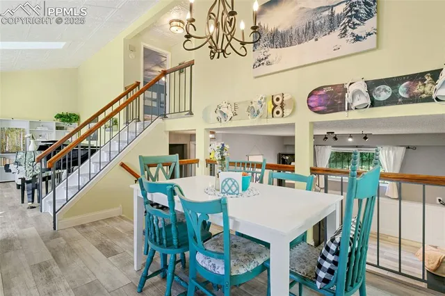 a view of a dining room with furniture wooden floor and a chandelier