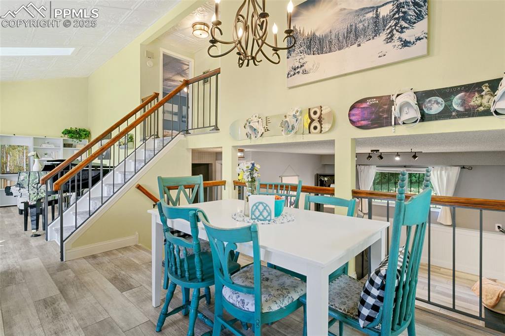 2960 Rio Vista Drive Colorado Springs, CO 80917 - Photo 10 of 32 a view of a dining room with furniture wooden floor and a chandelier