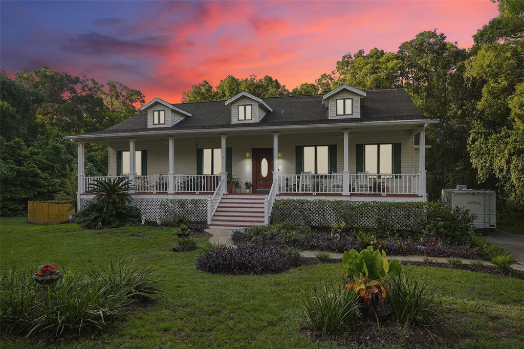 2836 Shenandoah Road DeLand, FL 32720 - Photo 1 of 46 a front view of a house with a yard table and chairs
