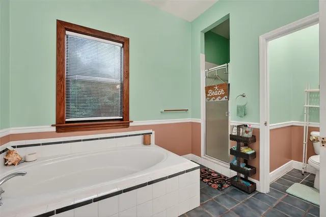 a bathroom with a bathtub and shower