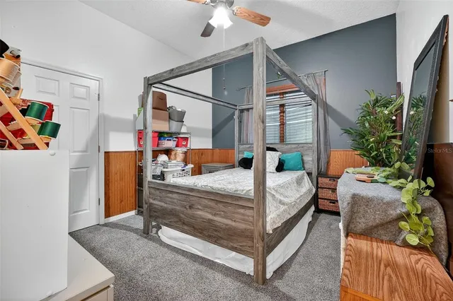 a bedroom with bed and a potted plant