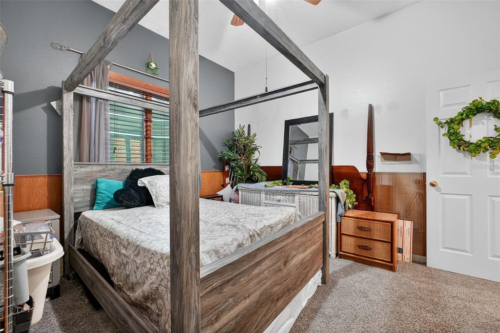 2836 Shenandoah Road DeLand, FL 32720 - Photo 17 of 46 a bedroom with a bed and large windows