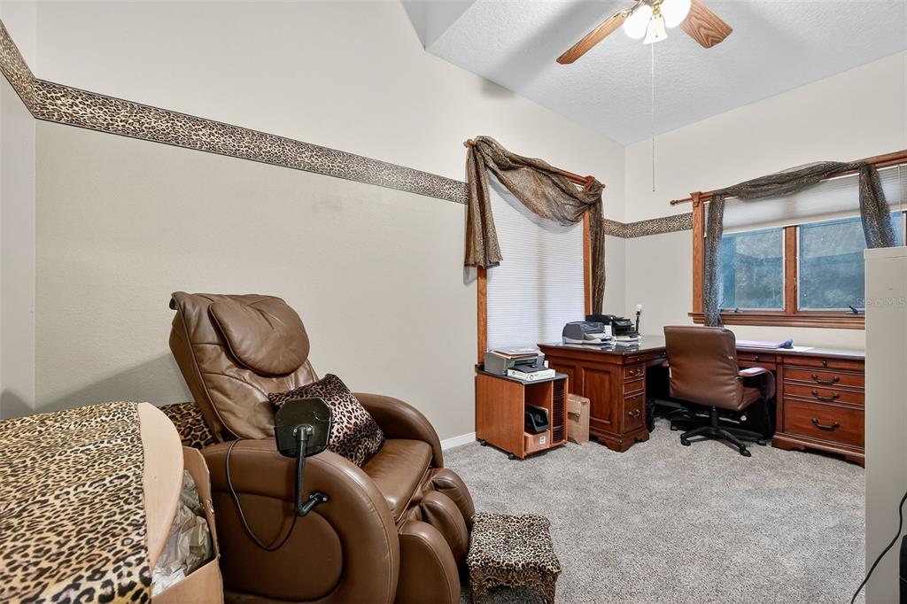2836 Shenandoah Road DeLand, FL 32720 - Photo 18 of 46 a living room with furniture a window and a chandelier
