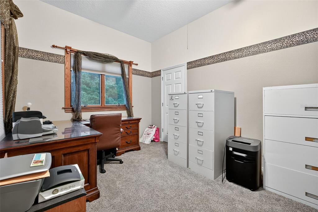 2836 Shenandoah Road DeLand, FL 32720 - Photo 19 of 46 a view of a workspace with furniture and a window