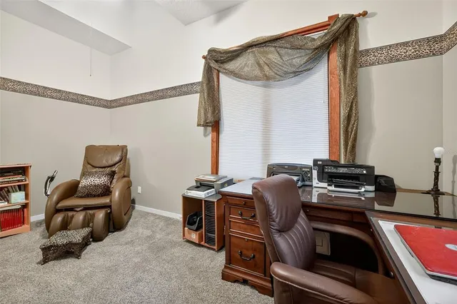 a room with chairs and a window