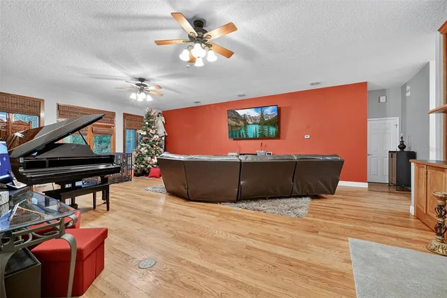 a living room with furniture a flat screen tv and a dining table