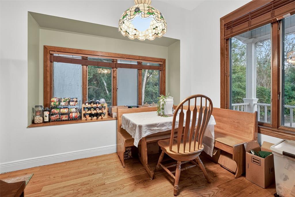 2836 Shenandoah Road DeLand, FL 32720 - Photo 27 of 46 a dining room with furniture a chandelier and wooden floor