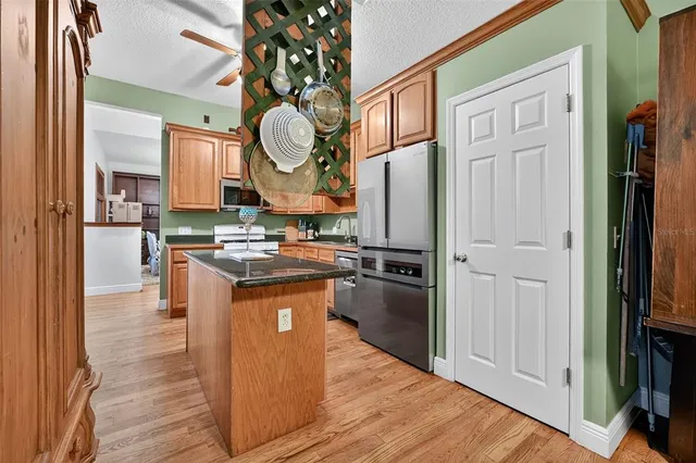 a kitchen with stainless steel appliances granite countertop a stove and a refrigerator