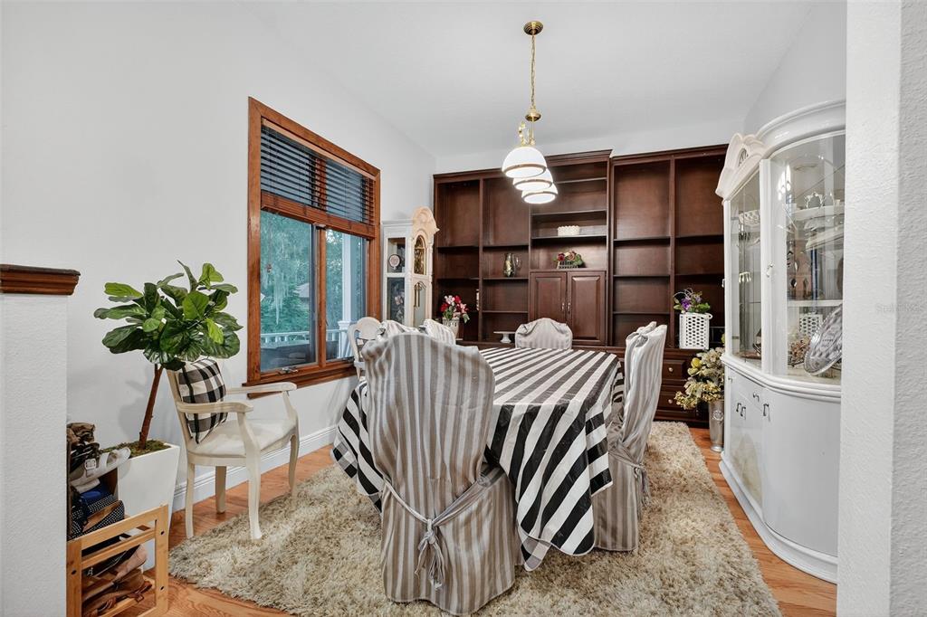 2836 Shenandoah Road DeLand, FL 32720 - Photo 29 of 46 a living room with furniture a chandelier and a dining table