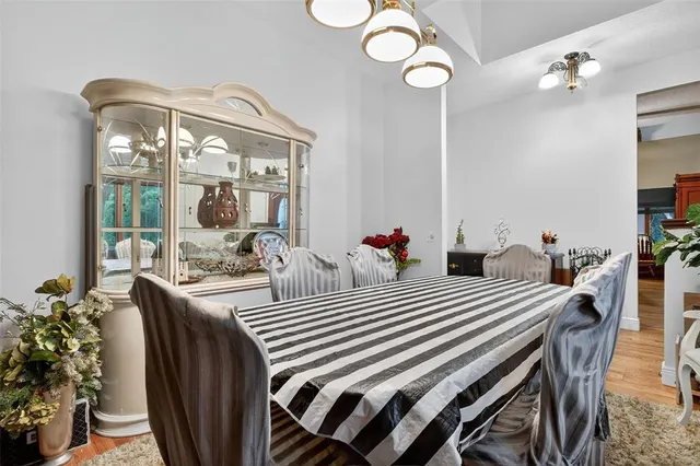 a view of a dining room with furniture wooden floor and chandelier