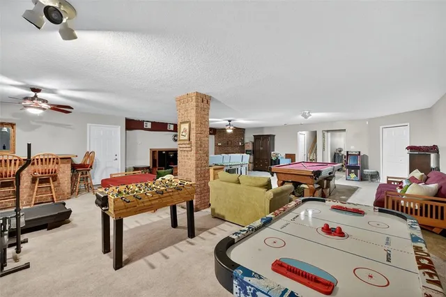 a living room with furniture a flat screen tv and a table
