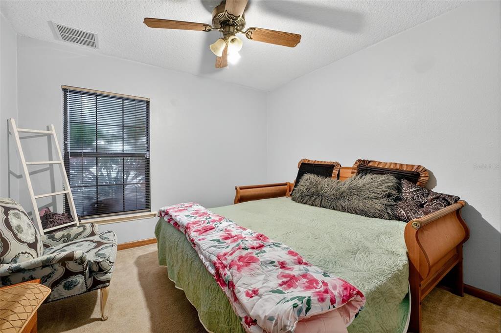 2836 Shenandoah Road DeLand, FL 32720 - Photo 35 of 46 a bedroom with a bed and wooden floor