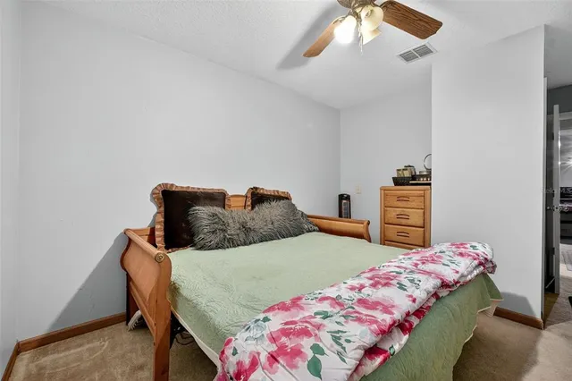 a bedroom with a bed and dresser