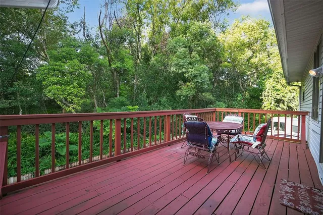 a view of a deck with table and chairs and wooden floor