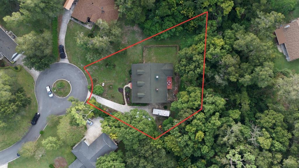 2836 Shenandoah Road DeLand, FL 32720 - Photo 42 of 46 an aerial view of a house with a yard and a lake view