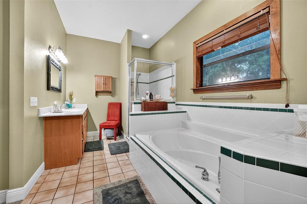 2836 Shenandoah Road DeLand, FL 32720 - Photo 10 of 46 a bathroom with a tub sink and mirror