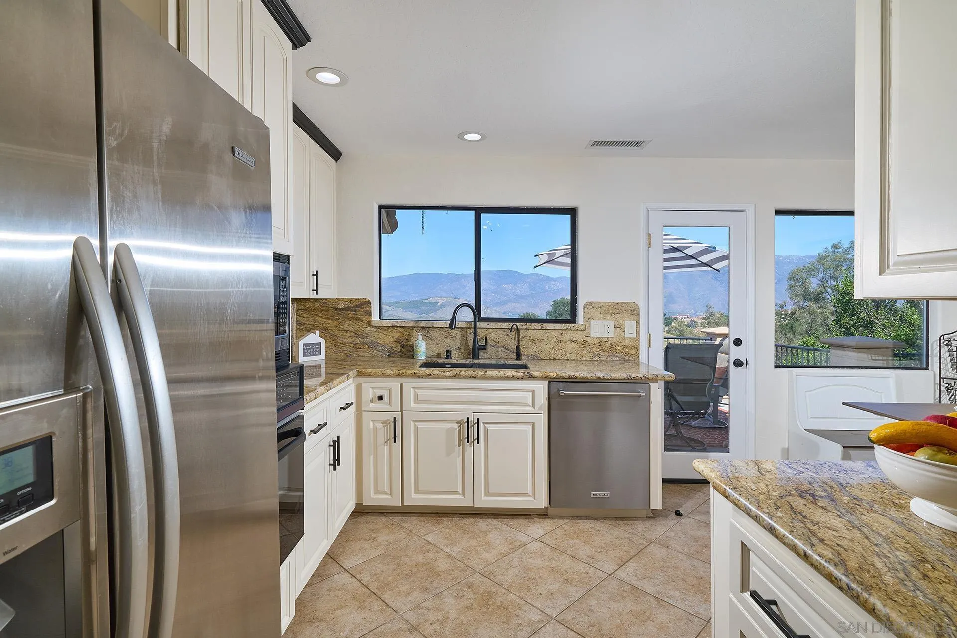 13588 McNally Road Valley Center, CA 92082 - Photo 13 of 43 a kitchen with a sink stainless steel appliances and cabinets