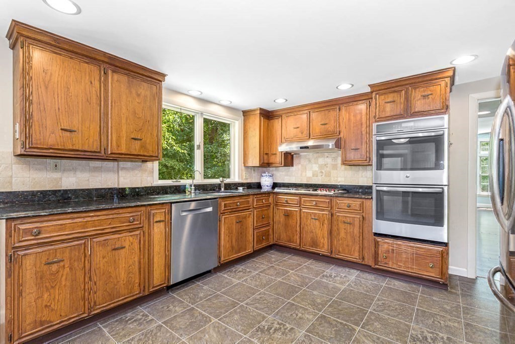 2 King George Drive Boxford, MA 01921 - Photo 11 of 41 a kitchen with stainless steel appliances granite countertop a stove a sink and a microwave