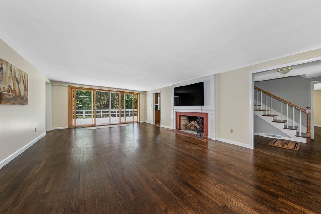 2 King George Drive Boxford, MA 01921 - Photo 17 of 41 a view of an empty room with wooden floor and a window