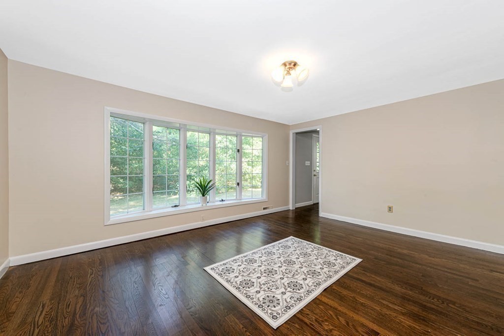 2 King George Drive Boxford, MA 01921 - Photo 20 of 41 a view of an empty room with wooden floor and a window