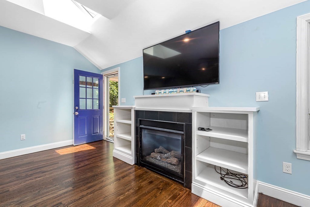 2 King George Drive Boxford, MA 01921 - Photo 22 of 41 a living room with flat screen tv a fire place and a fireplace