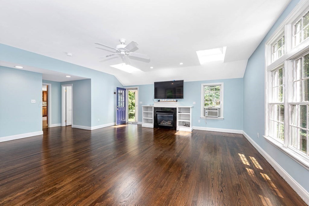 2 King George Drive Boxford, MA 01921 - Photo 28 of 41 a view of an empty room with window and wooden floor