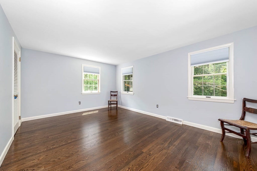 2 King George Drive Boxford, MA 01921 - Photo 39 of 41 an empty room with wooden floor and windows