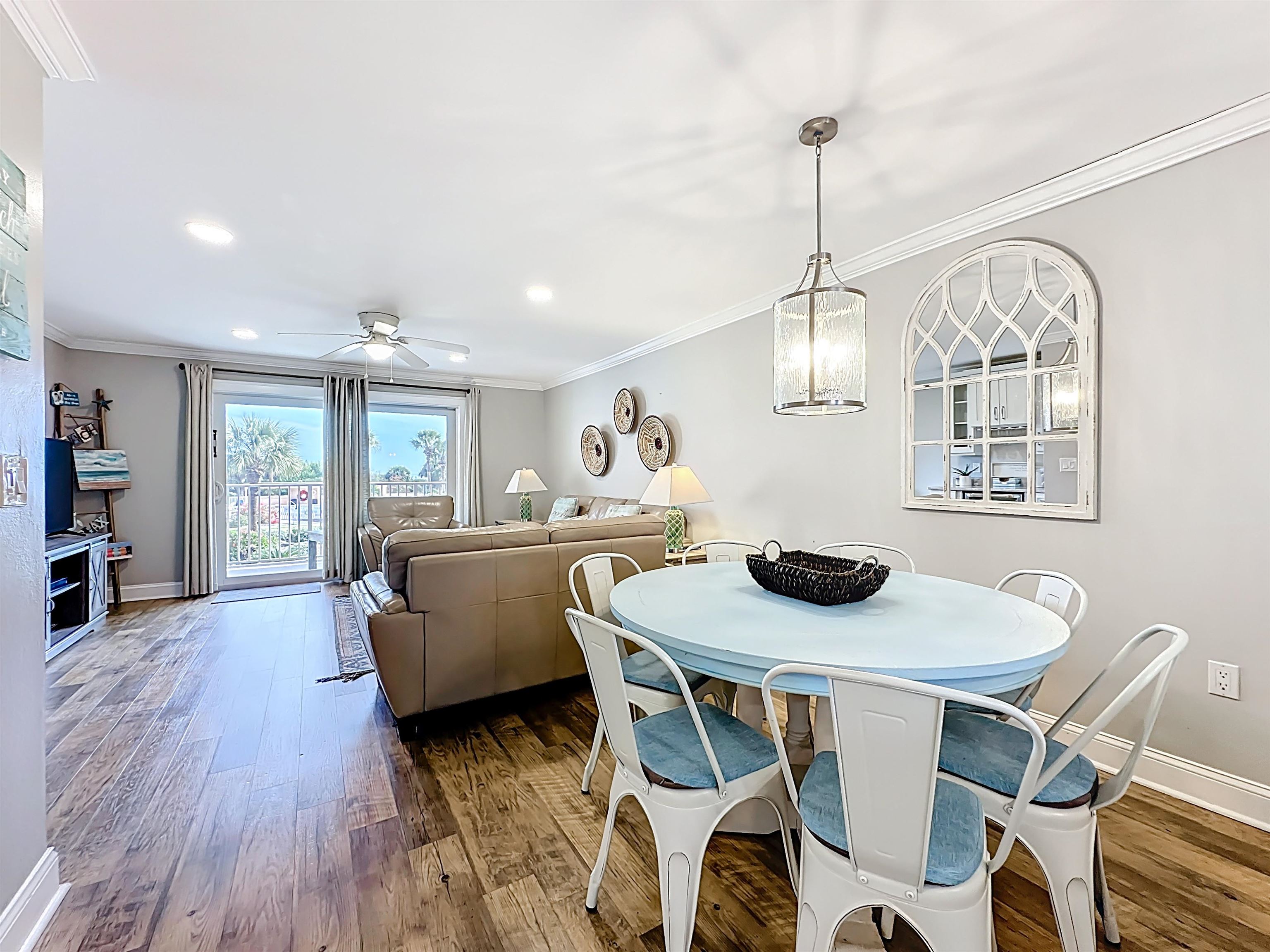 4 Ocean Trace Road, Unit 213 St. Augustine, FL 32080 - Photo 11 of 38 a dining room with furniture a window and wooden floor