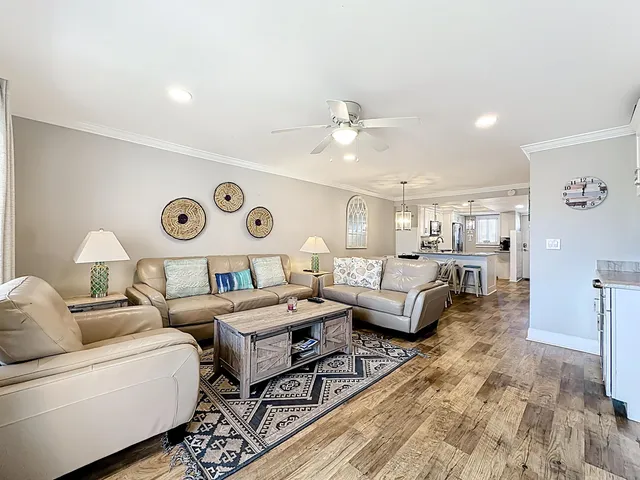 a view of a room with wooden floor and furniture
