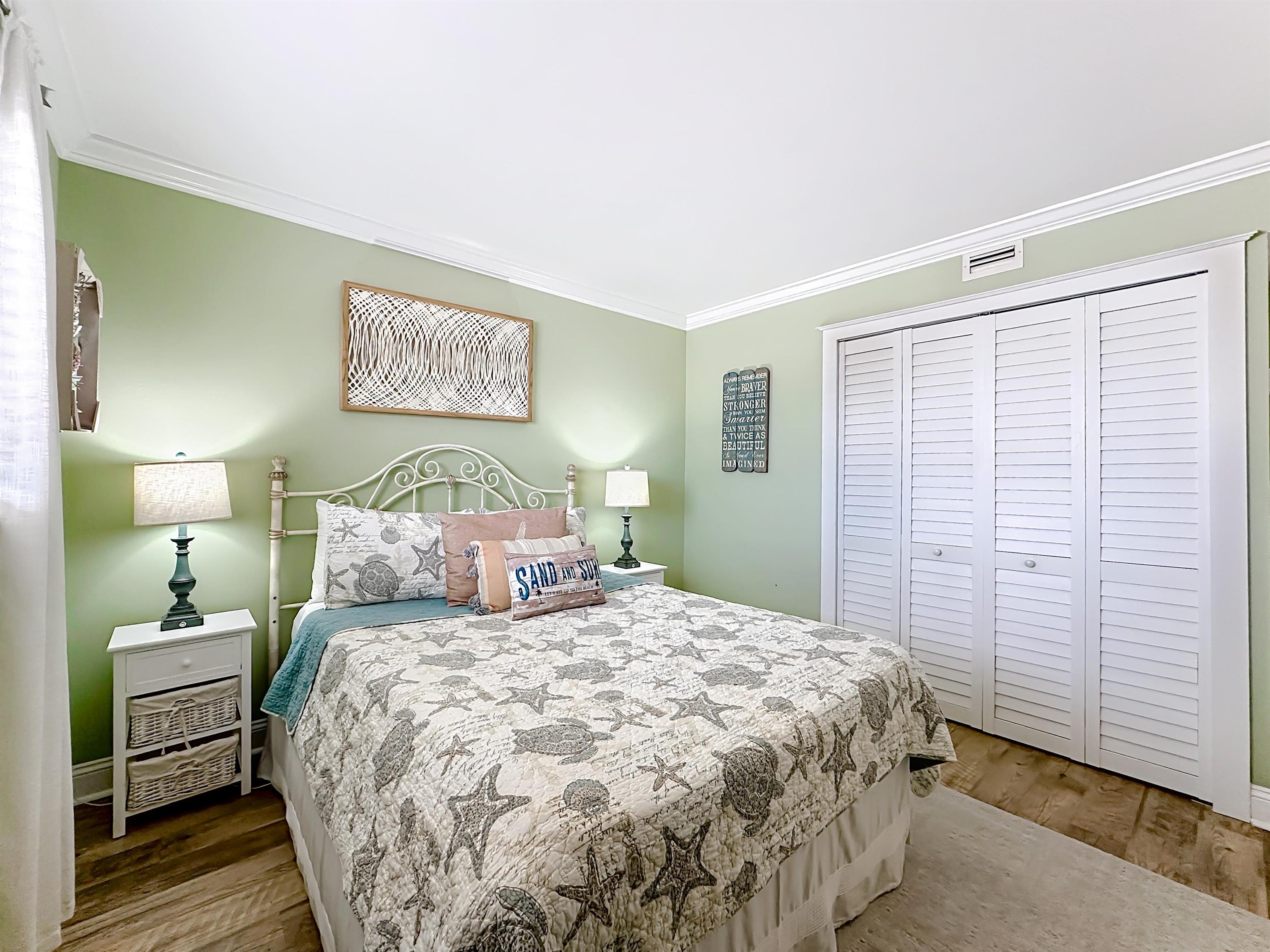 4 Ocean Trace Road, Unit 213 St. Augustine, FL 32080 - Photo 22 of 38 a bedroom with a bed and a night stand