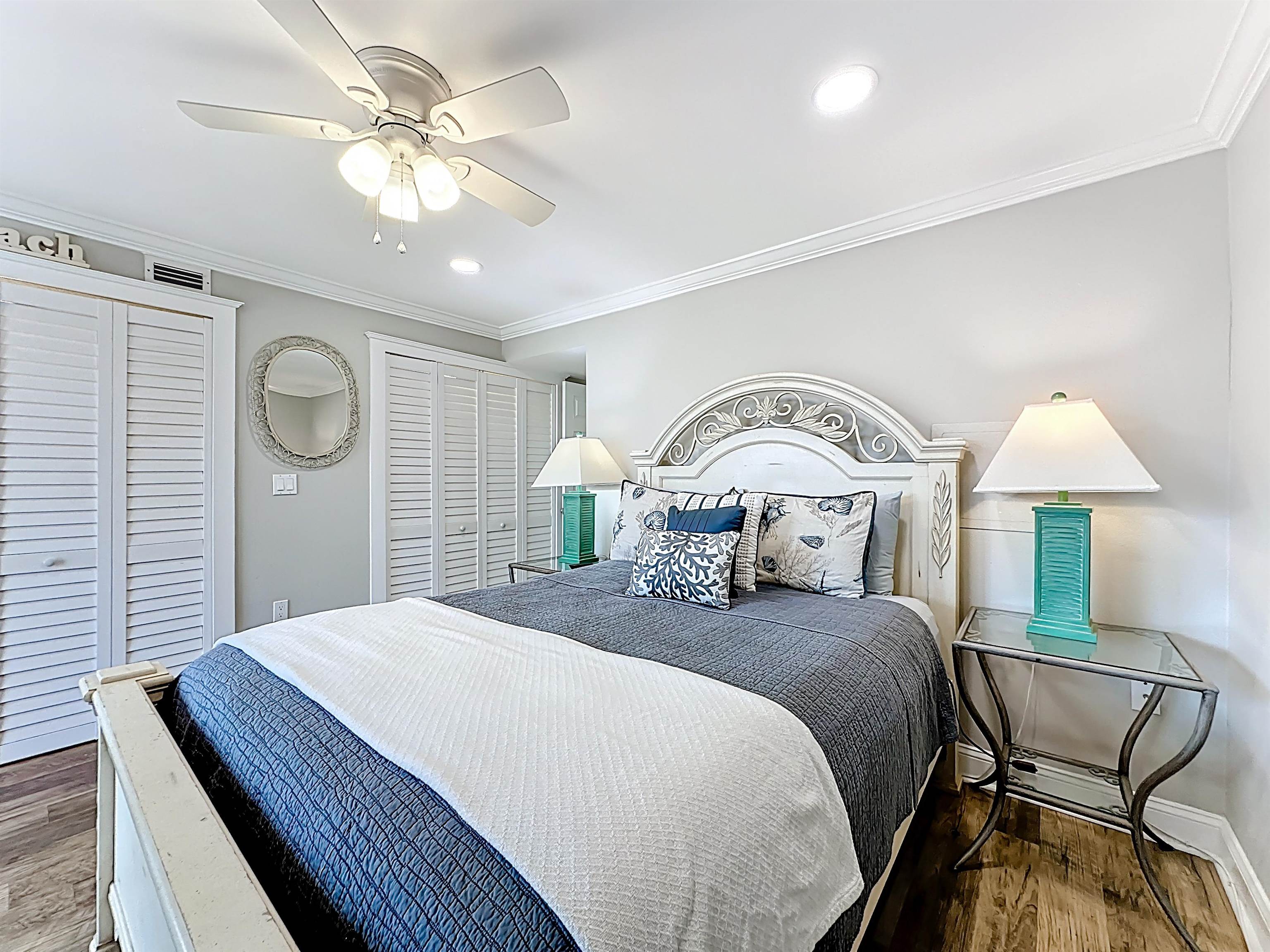 4 Ocean Trace Road, Unit 213 St. Augustine, FL 32080 - Photo 26 of 38 a bedroom with a bed and a chandelier