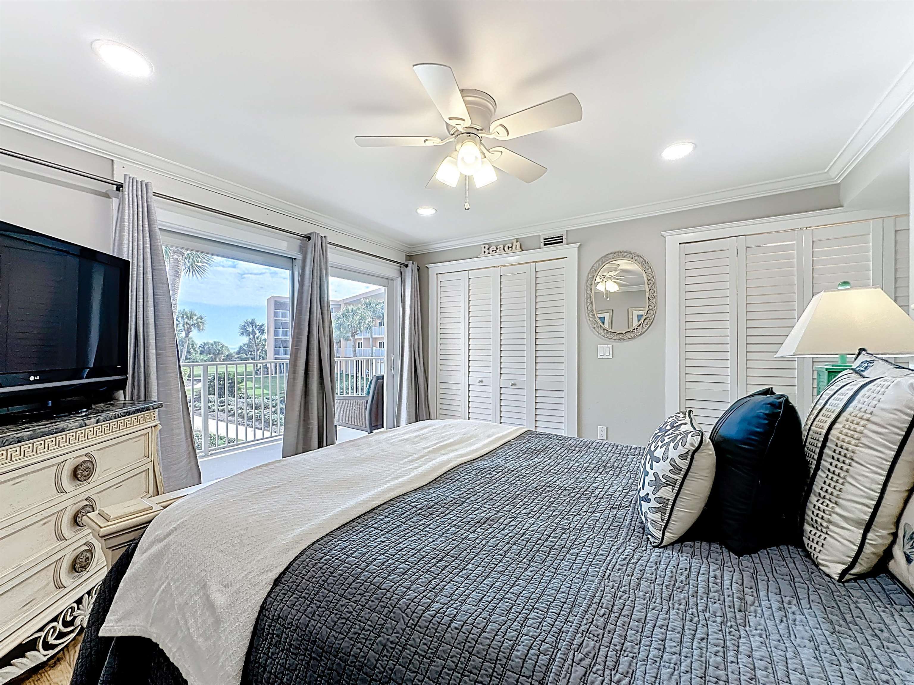 4 Ocean Trace Road, Unit 213 St. Augustine, FL 32080 - Photo 27 of 38 a bedroom with a bed and a flat screen tv