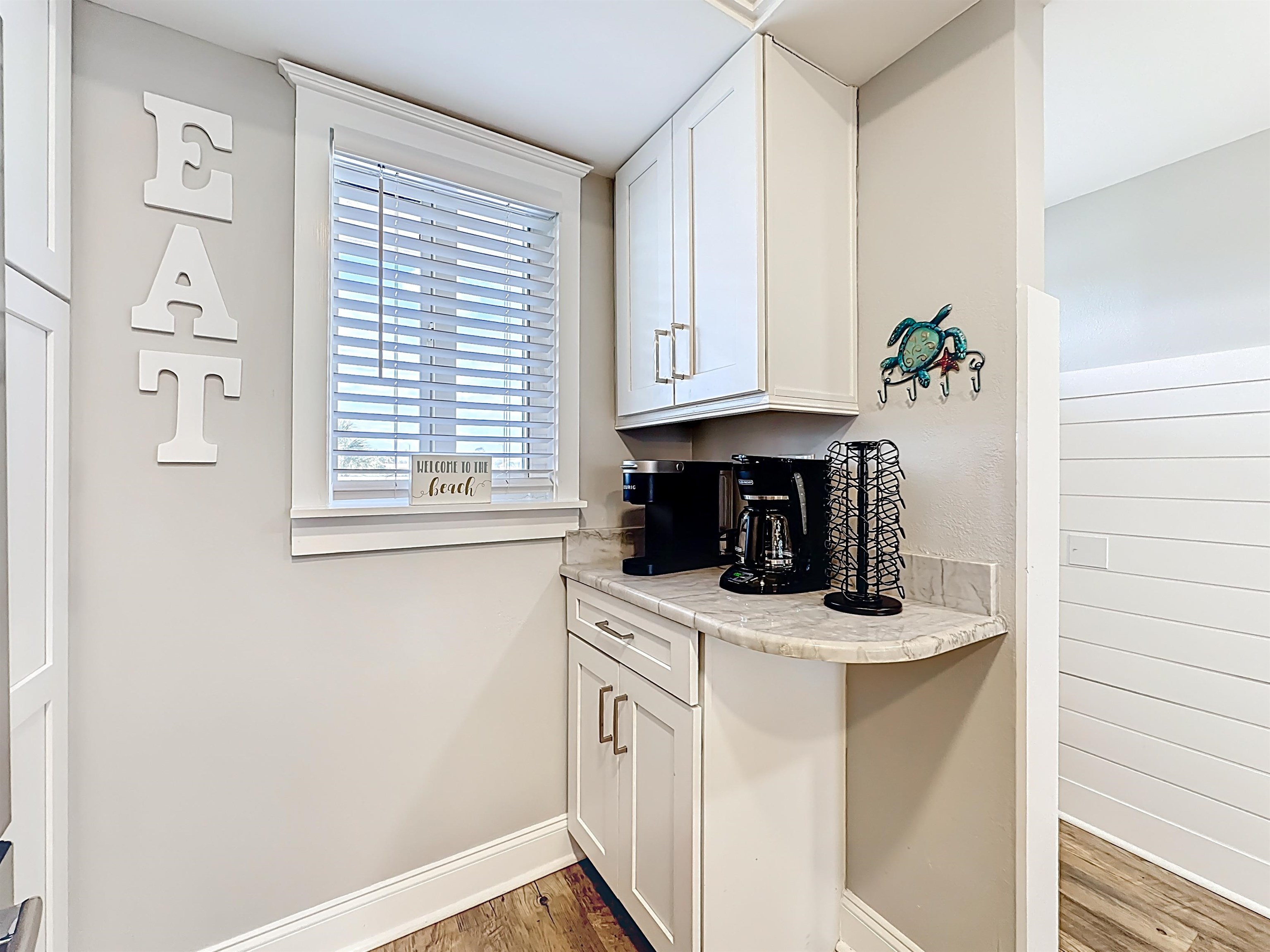 4 Ocean Trace Road, Unit 213 St. Augustine, FL 32080 - Photo 8 of 38 a kitchen with stainless steel appliances white cabinets and a window
