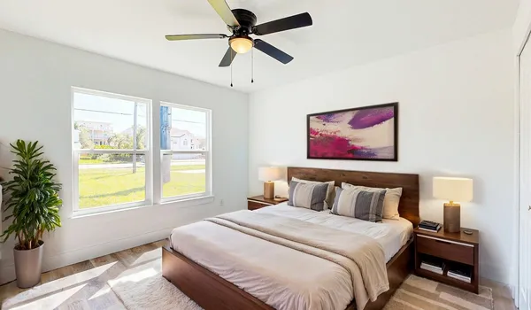 a bedroom with a large bed and a window