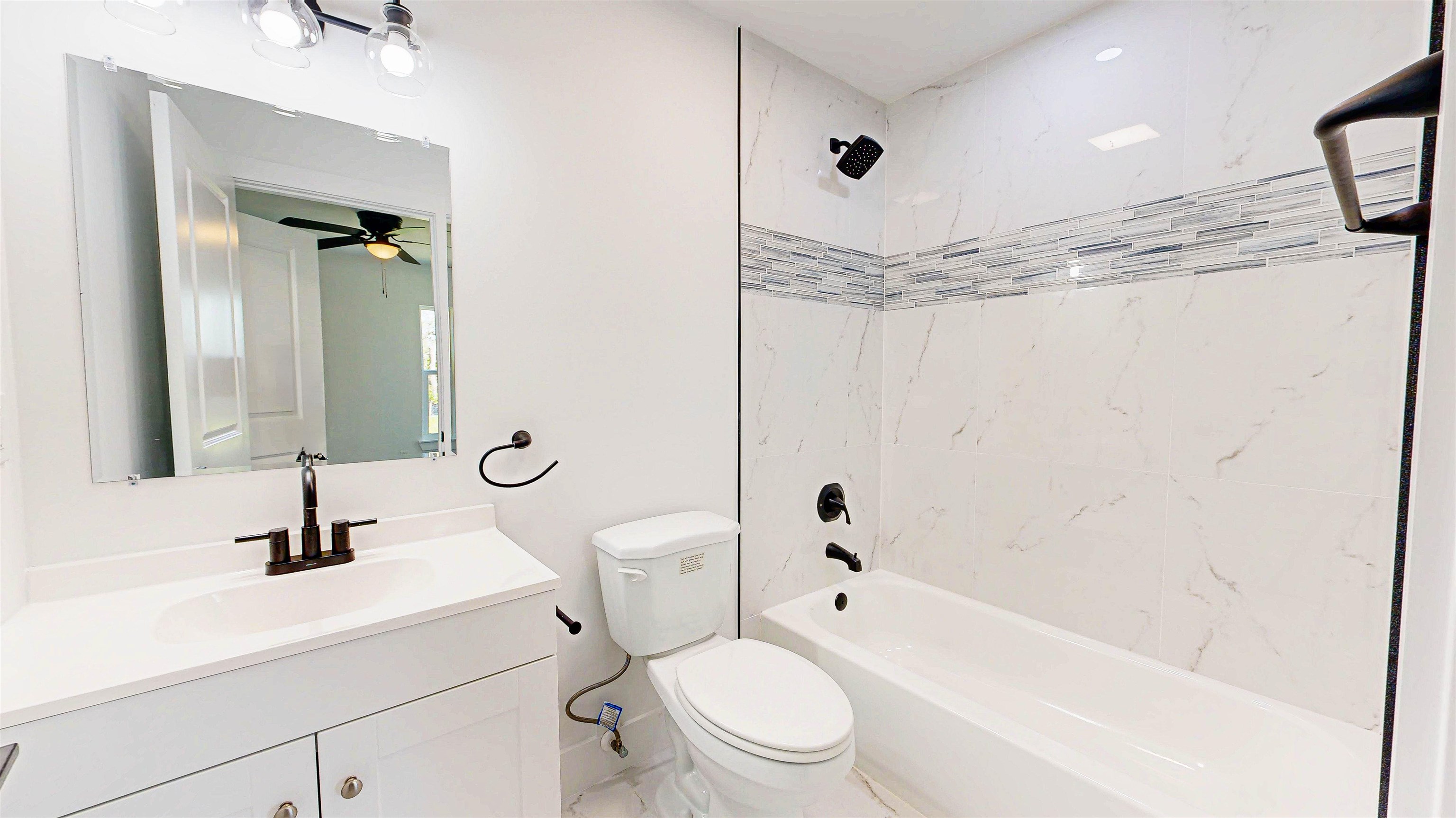 7975 A1A South St. Augustine, FL 32080 - Photo 16 of 33 a bathroom with a sink a toilet a mirror and shower