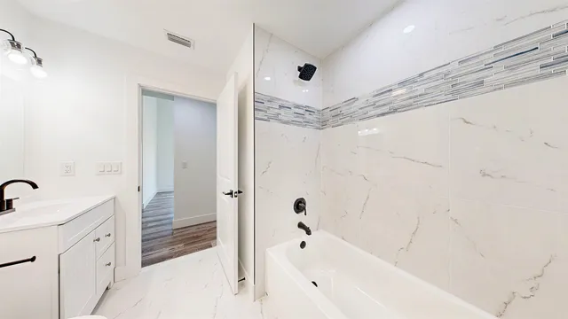 a bathroom with a toilet and a bath tub