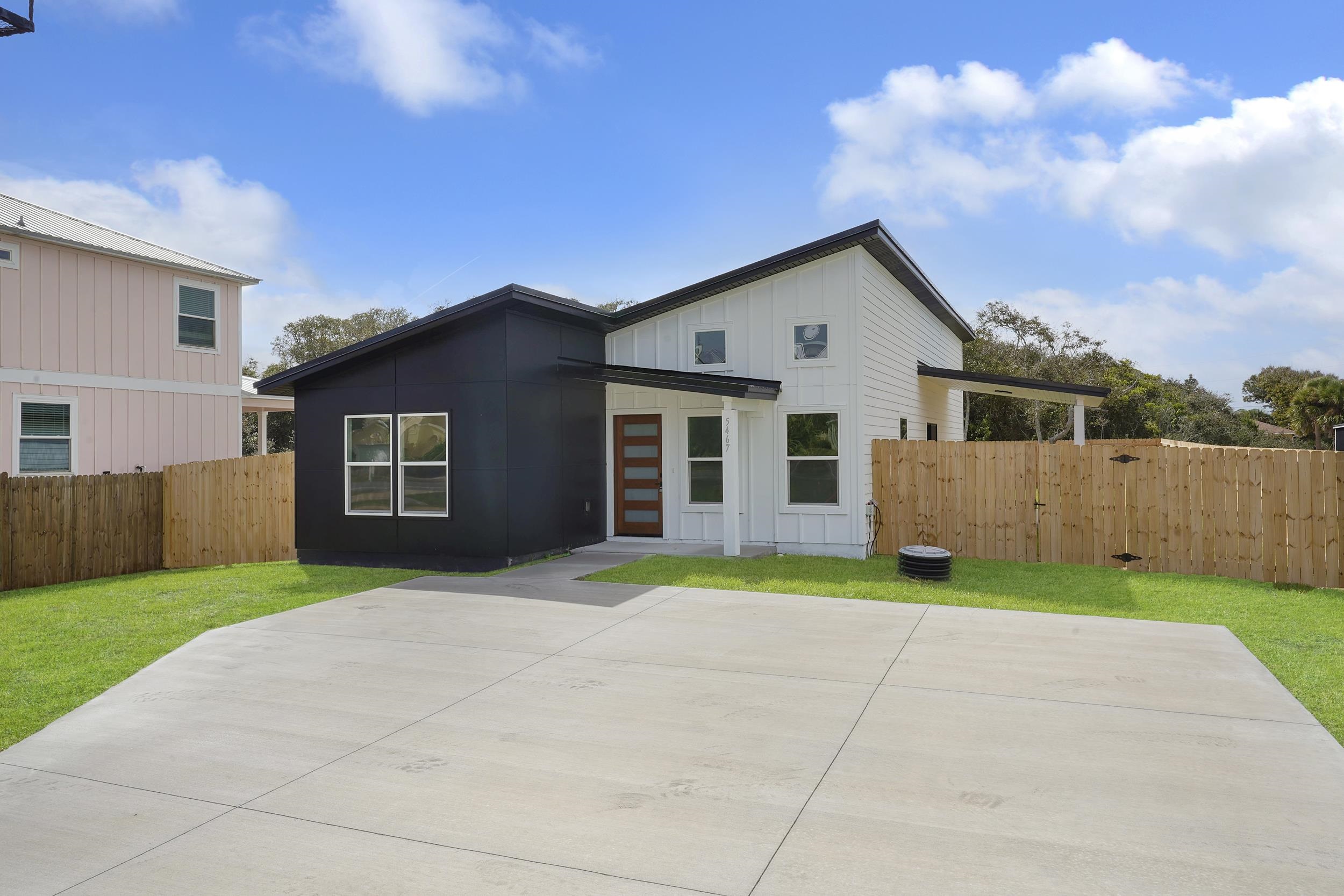 7975 A1A South St. Augustine, FL 32080 - Photo 3 of 33 a front view of a house with a yard and garage