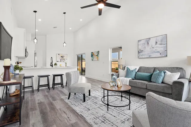 a living room with furniture a rug and a flat screen tv
