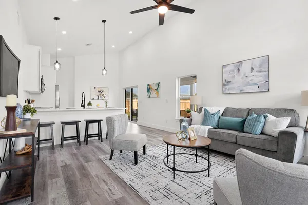 a living room with furniture a rug and a flat screen tv