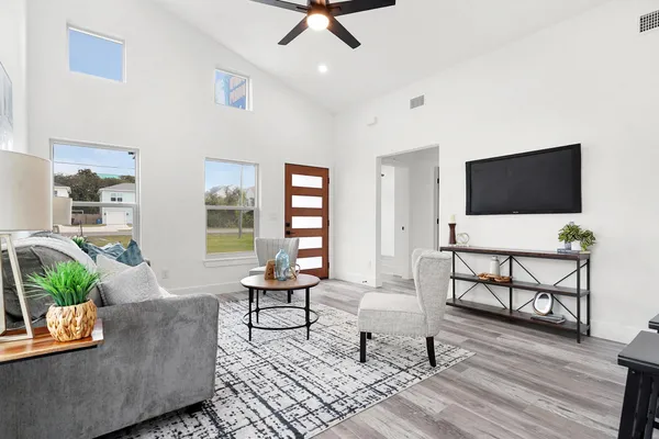 a kitchen with kitchen island a dining table and chairs