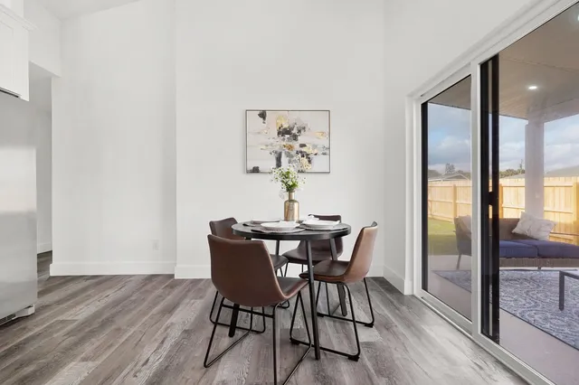 a kitchen with stainless steel appliances kitchen island a refrigerator sink and white cabinets