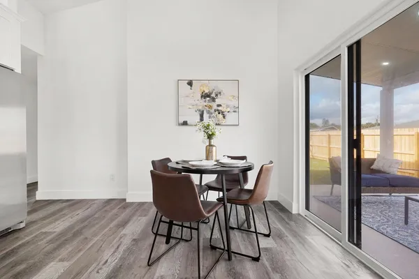 a kitchen with stainless steel appliances kitchen island a refrigerator sink and white cabinets