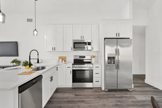 a kitchen with a sink stove and microwave