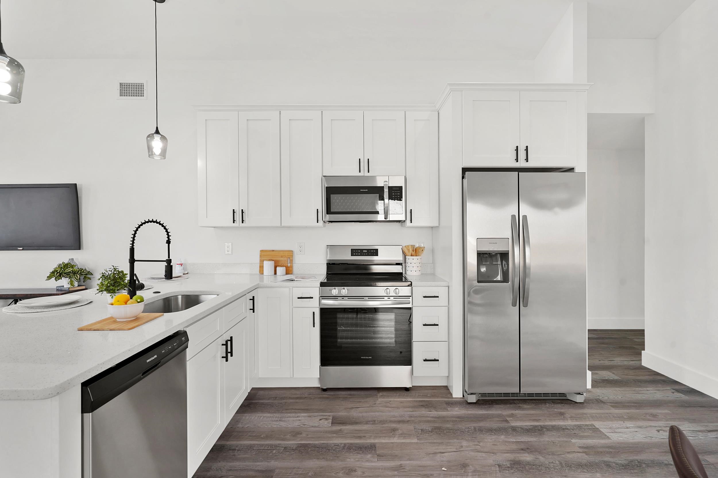 7975 A1A South St. Augustine, FL 32080 - Photo 10 of 33 a kitchen with stainless steel appliances kitchen island a refrigerator sink and white cabinets
